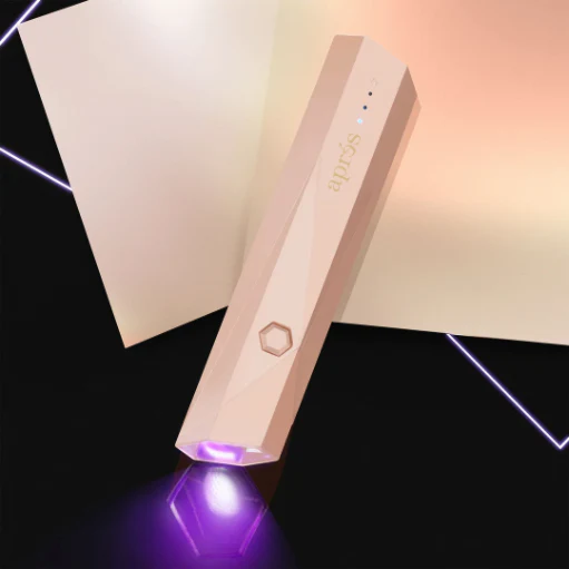 The Omega Mini Flash Cure Light from Apres in the pink color, a portable LED nail lamps