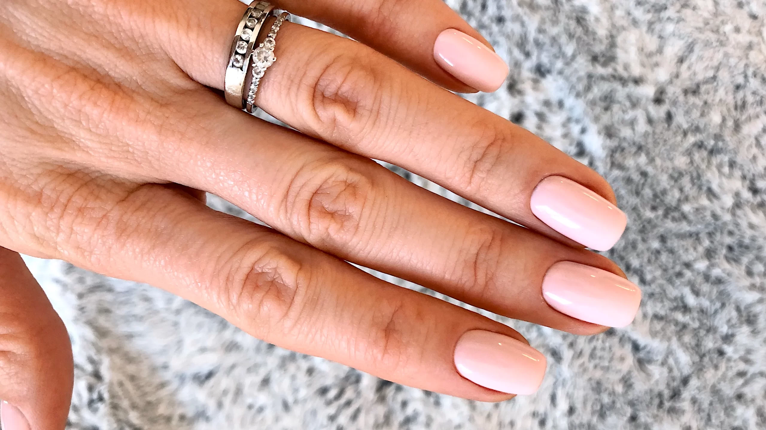 Woman's hand with pink squoval nails