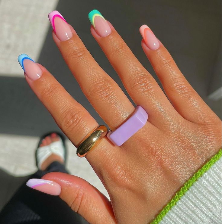 A woman's hand with Squoval Nails in fun summer colors in the French way