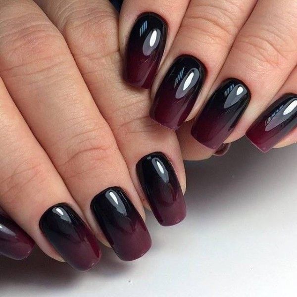 A woman's nails in burgundy ombre to suits the vibes of the fall designs