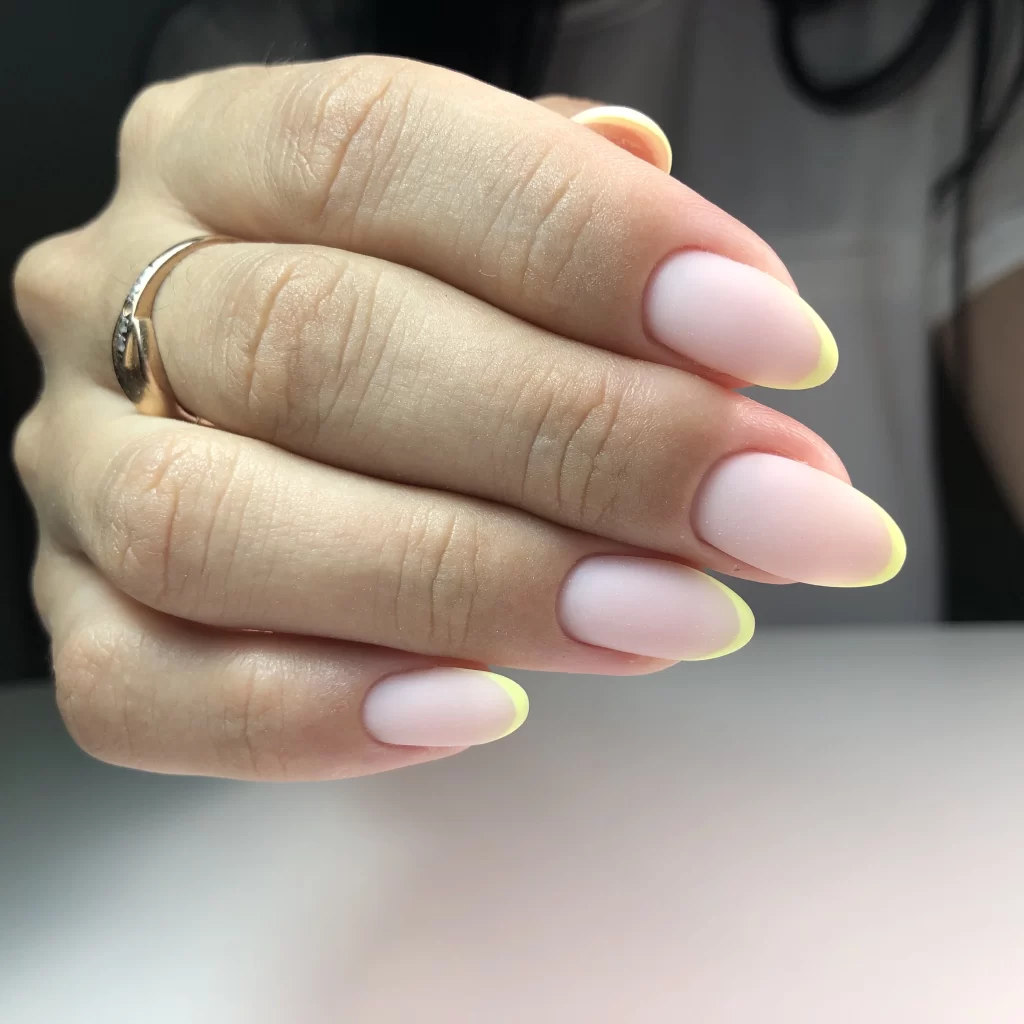 A French woman's fingernail tips in yellow