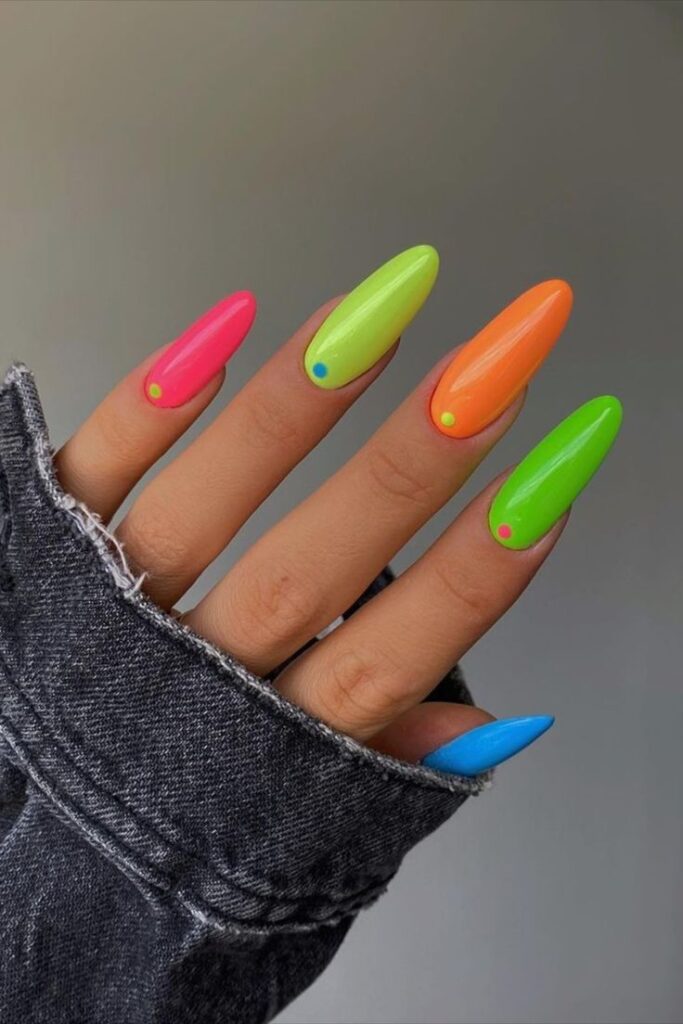 Woman's nails with Vibrant Neon Pop art, party nail trends