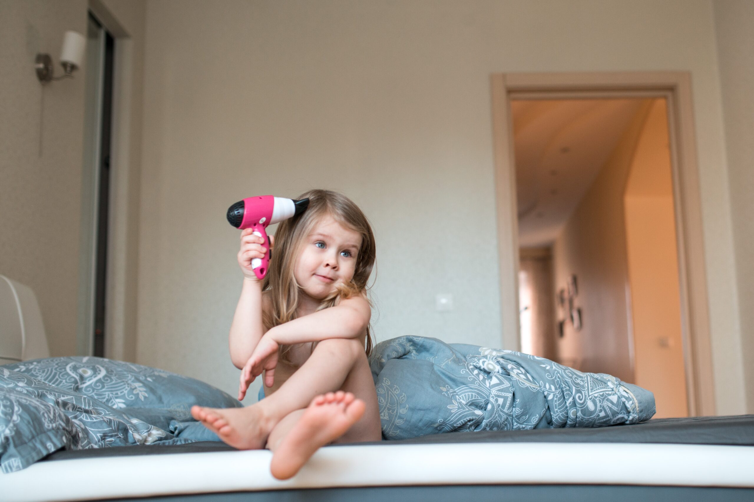 funny-girl-in-bedroom-with-hairdryer-2022-11-14