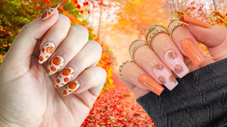 A woman's nails are decorated with Halloween-inspired pumpkins and leaves.