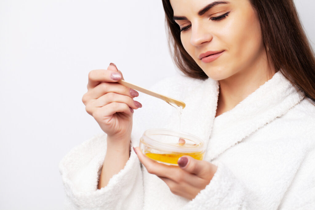 young-woman-uses-liquid-wax-to-remove-hair-2023