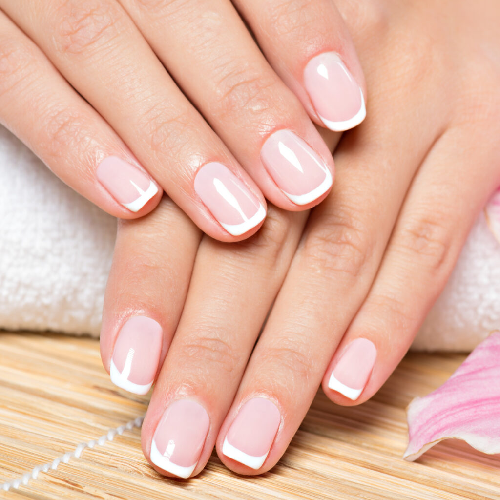 beautiful-woman-s-nails-with-french-manicure-2021-08-26