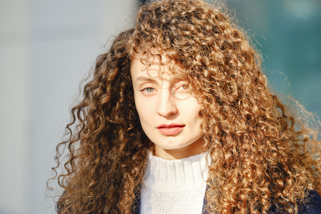 portrait-of-a-woman-with-brown-curly-hair-2023-11-27