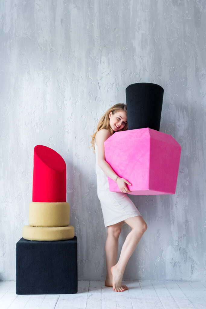 attractive girl posing with big nail polish and red lipstick