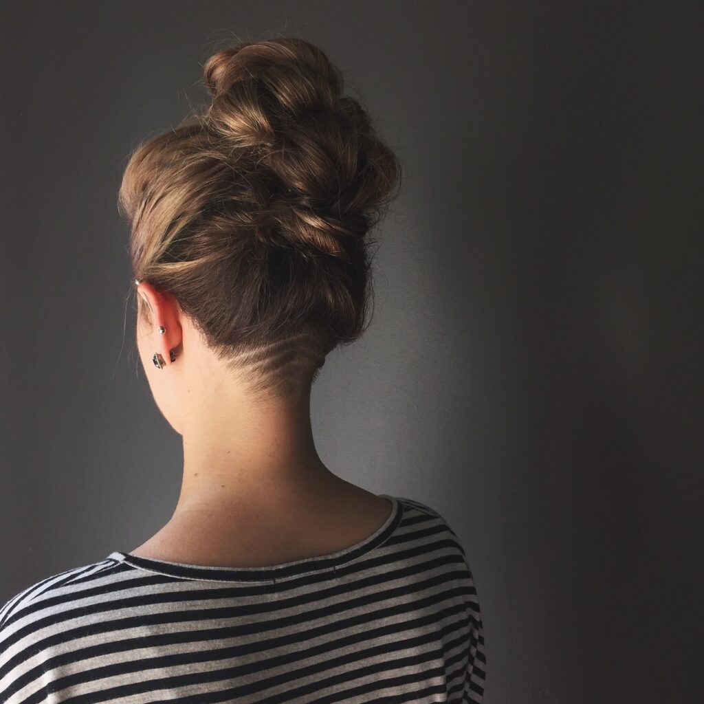 Back view of undercut and updo of hair. A hair trend for 2024