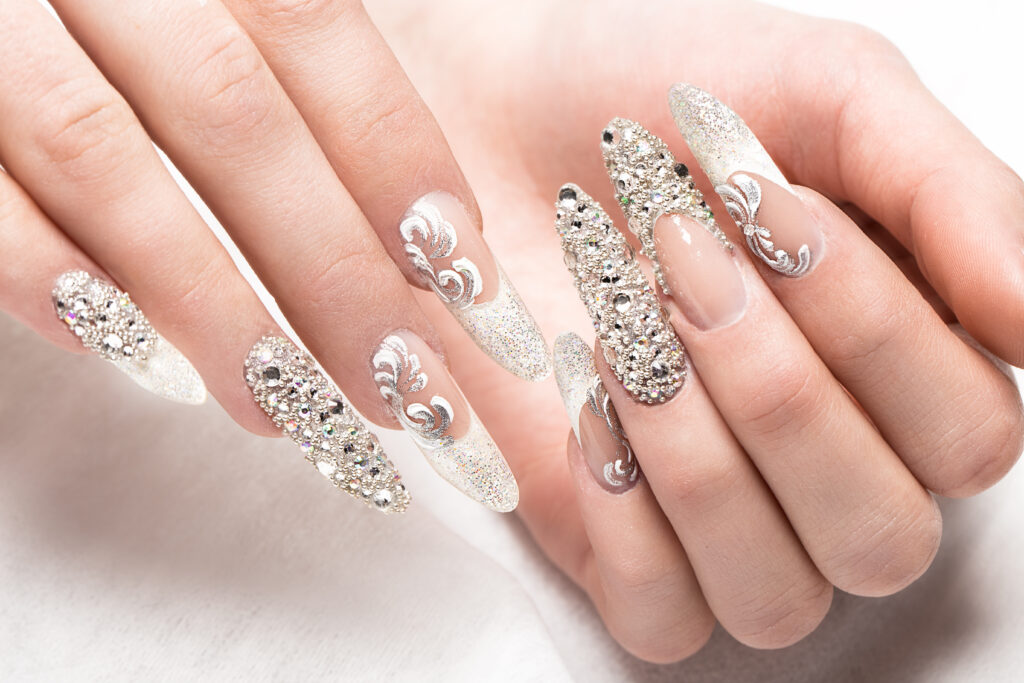 Beautifil wedding manicure for the bride in gentle tones with rhinestone. Nail Design. Close-up. Wedding Nail Designs