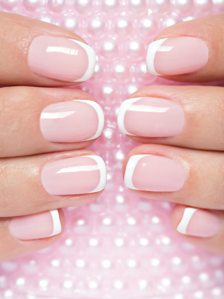 Beautiful woman's nails with french manicure