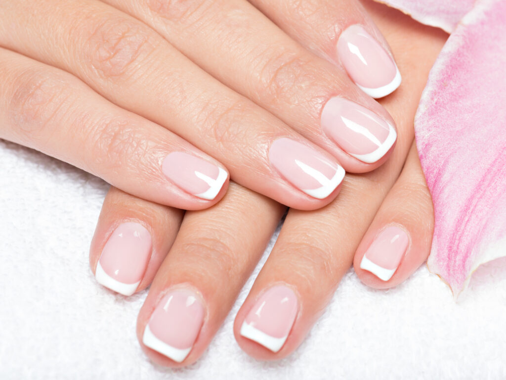 Beautiful woman's nails with french manicure