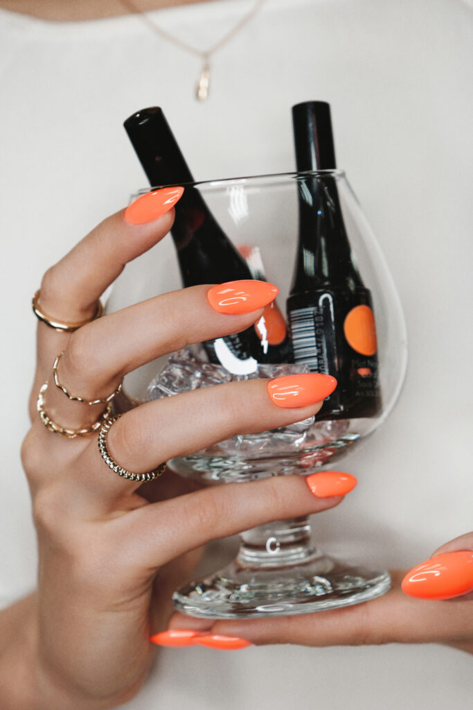 Bright neon manicure on female hands with accessories. Nail design. Beauty
