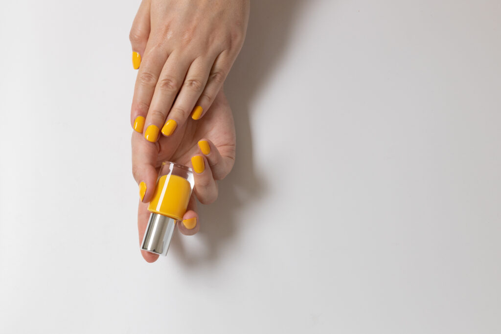 bright-yellow-manicure-with-a-bottle-of-nail-polis-2023-11-27