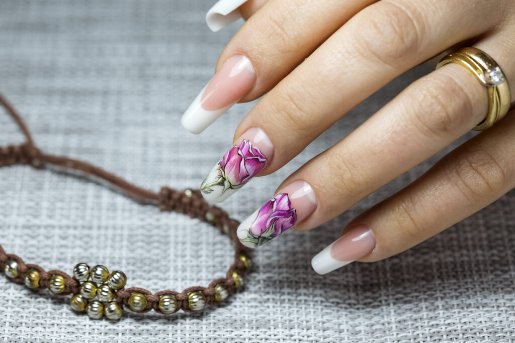 Beautiful multicolored flowers on a transparent lacquer on the nails on a gray decor, Nail Art Designs, Wedding Nail Designs