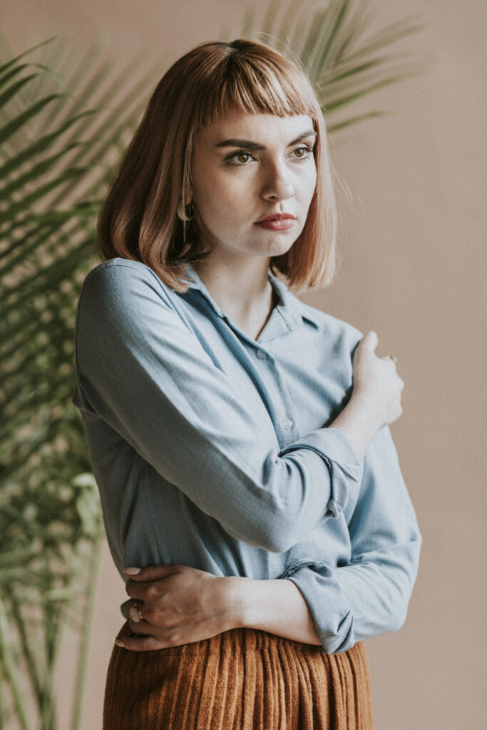 Portrait of a beautiful woman wearing a blue shirt, Haircut and Color Trends