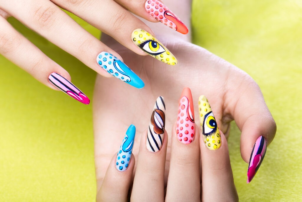 Long beautiful manicure in pop-art style on female fingers. Nails design. Close-up. Nail Art Designs