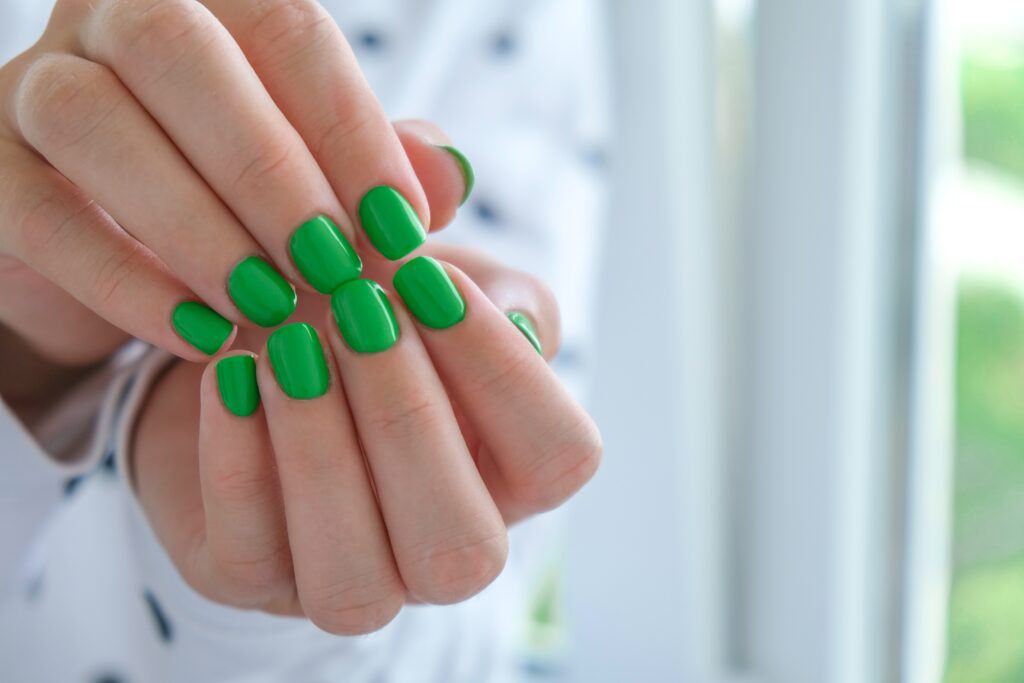 manicured-female-hands-with-stylish-green-nails-t-2022-11-09