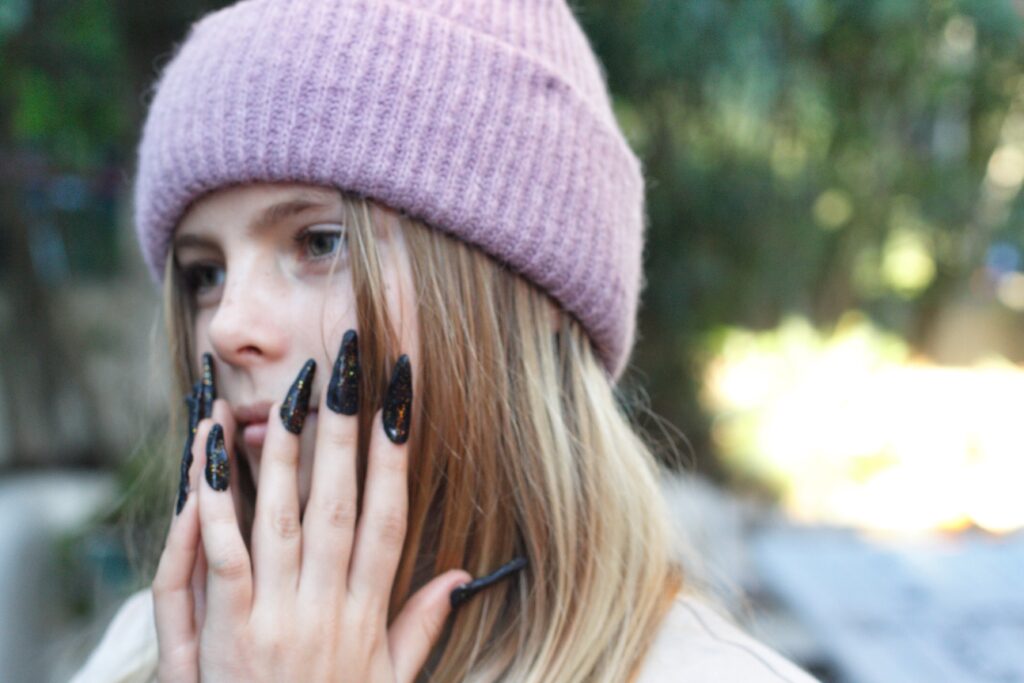 portrait of a girl with a purple beanie hat and lo