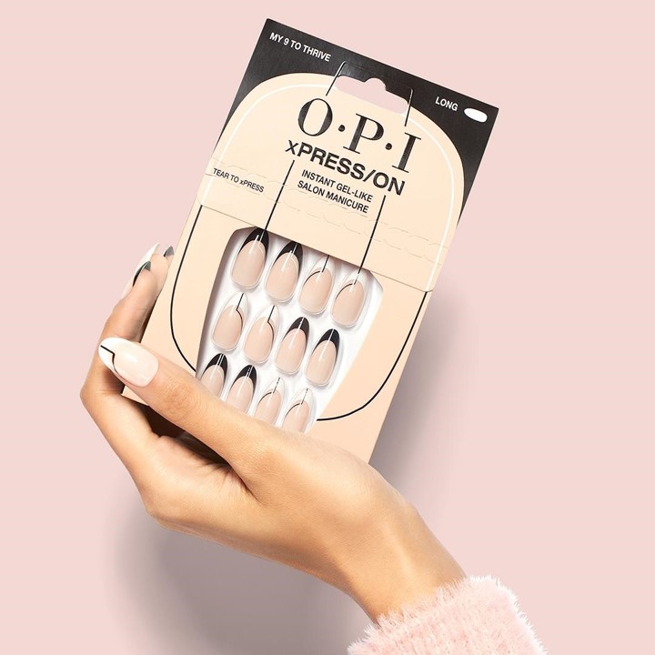 A faceless woman holding the OPI xPRESS/On nail tips, Gel like nail extension. 