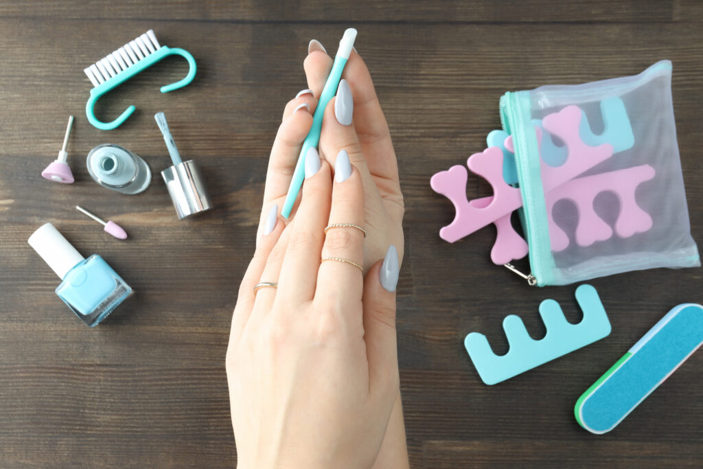 Concept of nail care with manicure accessories on a wooden background