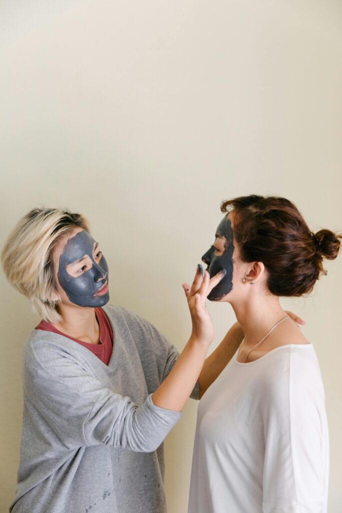 two women are doing their morning skincare together and applying facial masks