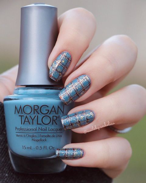 A faceless woman holds a Morgan Taylor glitter nail polish bottle, her nails painted in the same enchanting shade with silver and brown nail designs.