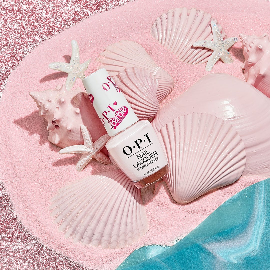 An OPI nail polish bottle shade on a pinky beach background, OPI Nail Polish Shades. OPI Nail Lacquer