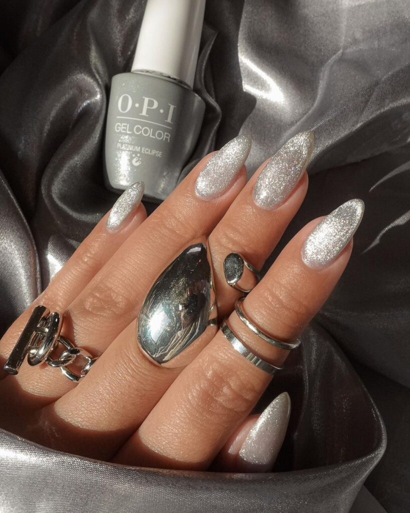 A faceless woman nails painted with the OPI Platinum Eclipse Velvet Vision Gel Effects shade. An OPI Velvet Vision Gel Effects bottle in gray shade.