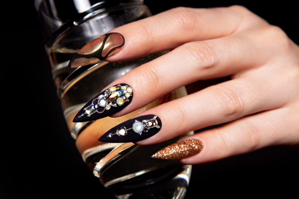 Black and gold manicure with diamonds. High-quality photo. nail trends. nail designs. diamond nails. 2024 nail designs