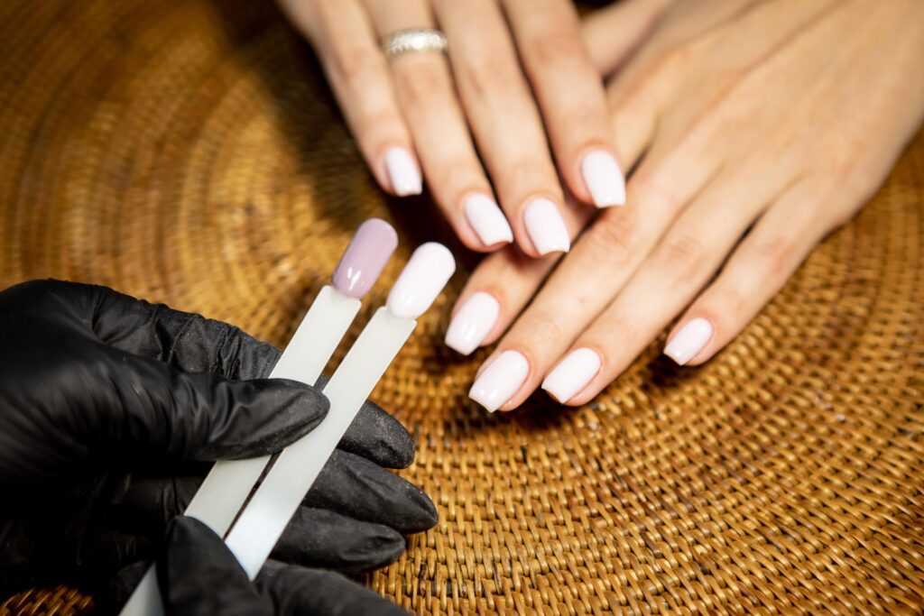 A faceless woman is choosing nail tips that suits her nail shape 