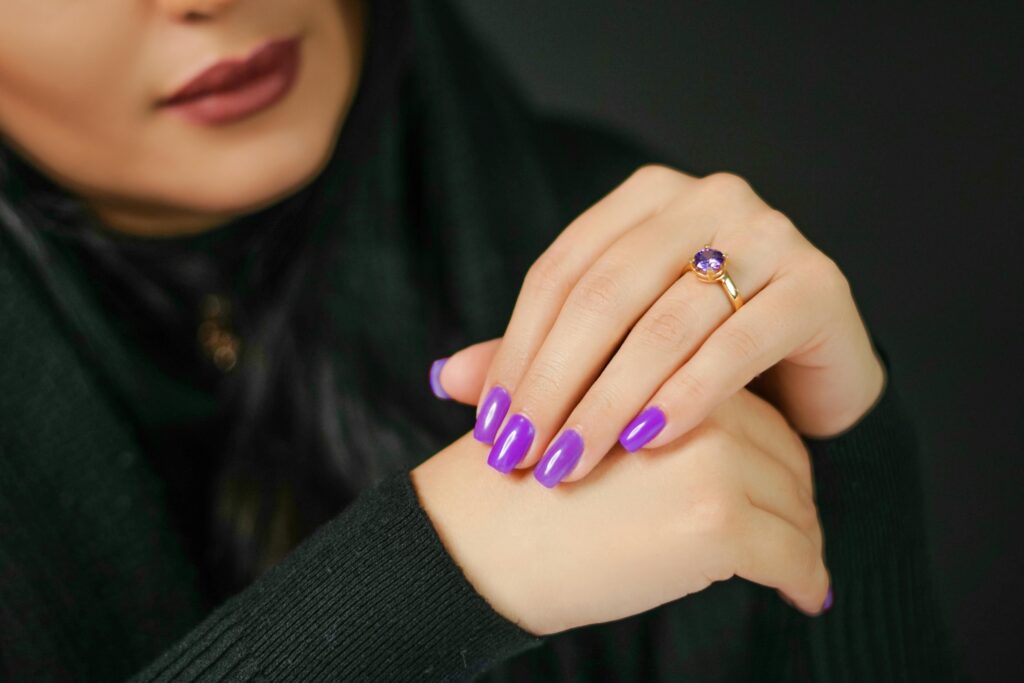 a faceless woman with light purple painted nails.  2024 nail trends