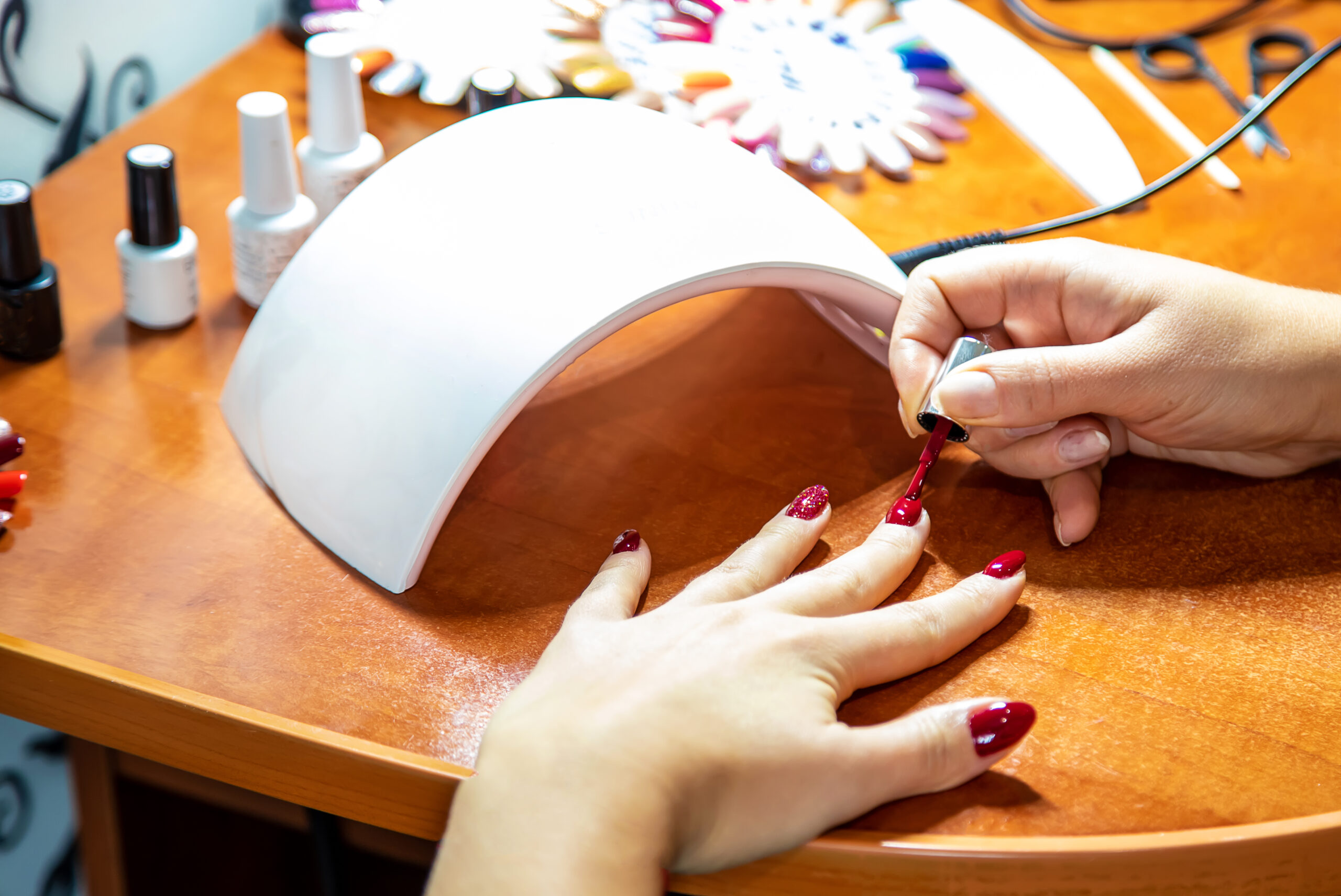 manicure at home, gel polish, dry in the lamp. Selective focus. beauty. nail polish for fair skin