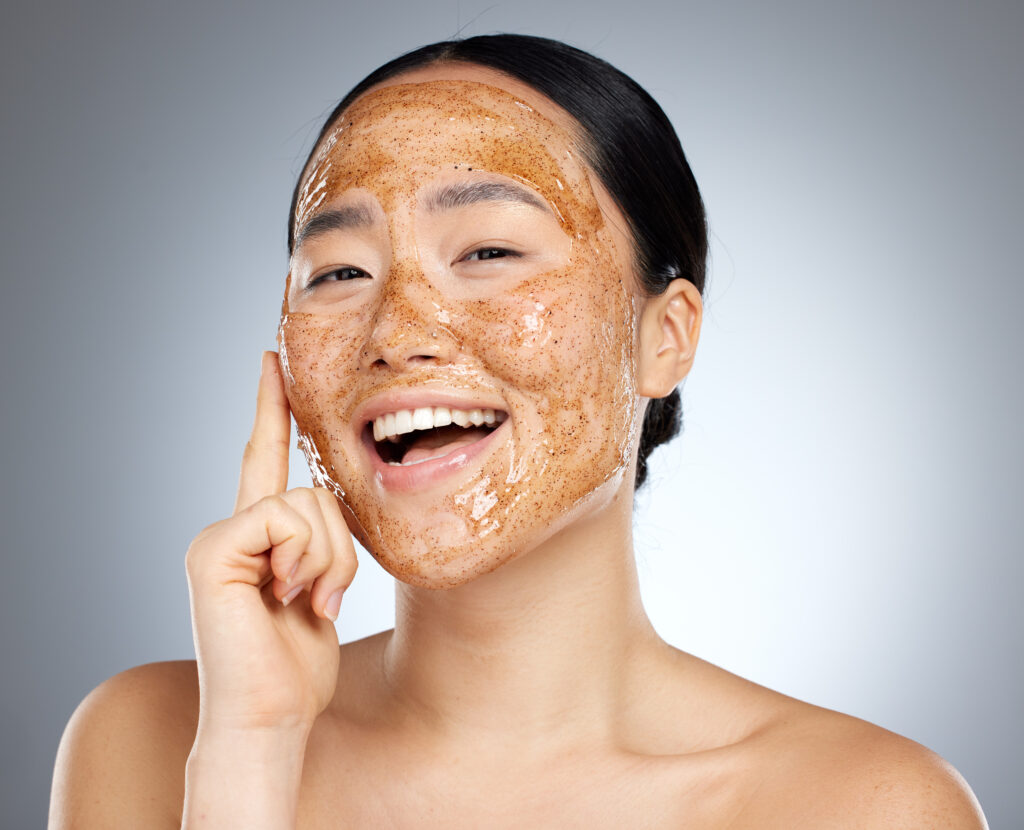 Skincare, portrait and woman with a coffee face mask for fresh, clean and beautiful skin in studio