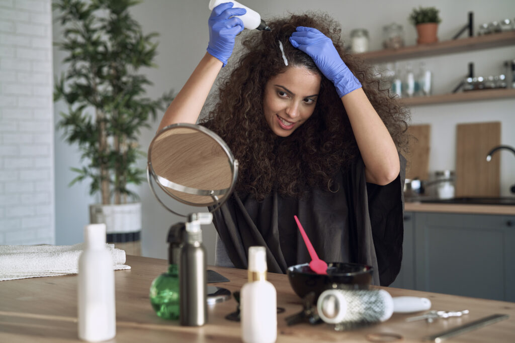 Woman perming her hair at home. DIY hair 