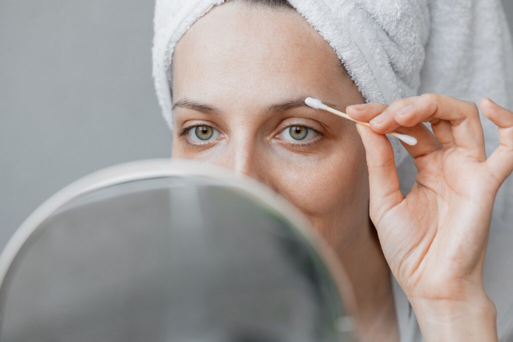 A woman is cleaning her eyebrow at home. DIY eyebrow cleaning