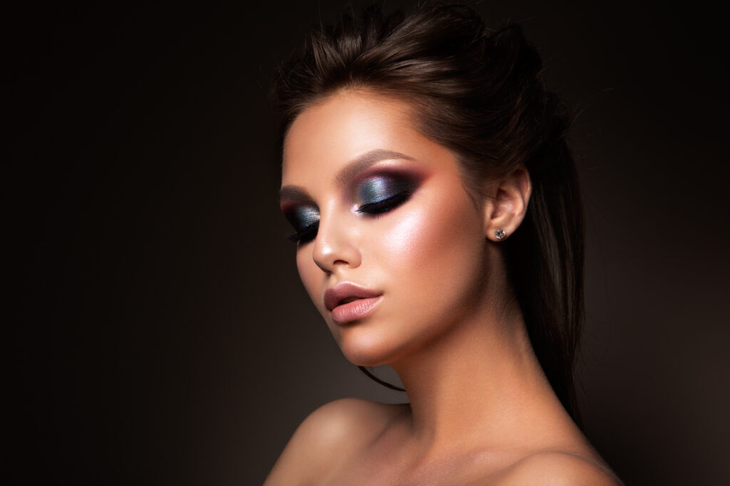 Close-up of beautiful female face with colorful make-up and lips, eyes closed