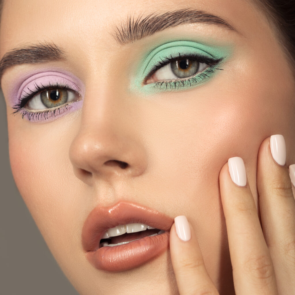 Fashion portrait of young woman. Colorful eye shadows. Perfect skin.