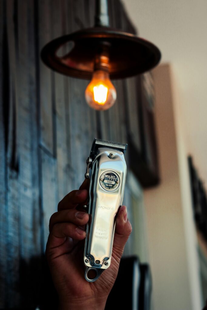 A faceless man holding an WAHL hair trimmer