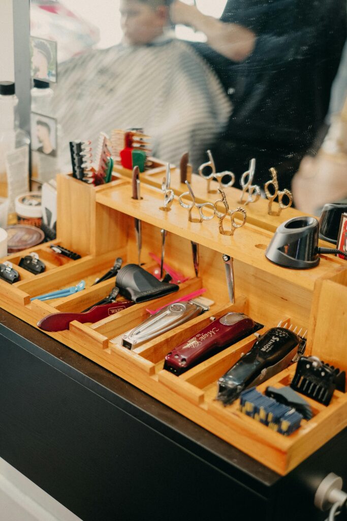 Different types and sizes of hair trimmers, scissors and hair combs.