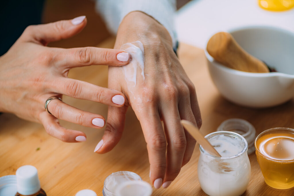 Ingredient Sensitivities. Woman Applying Homemade Hand Cream onto her Hands. skin care. body care.