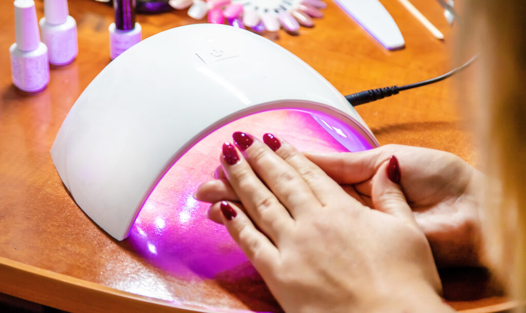 manicure at home, gel polish, dry in the lamp. Selective focus. beauty. gel polish. manicure. long lasting manicure.