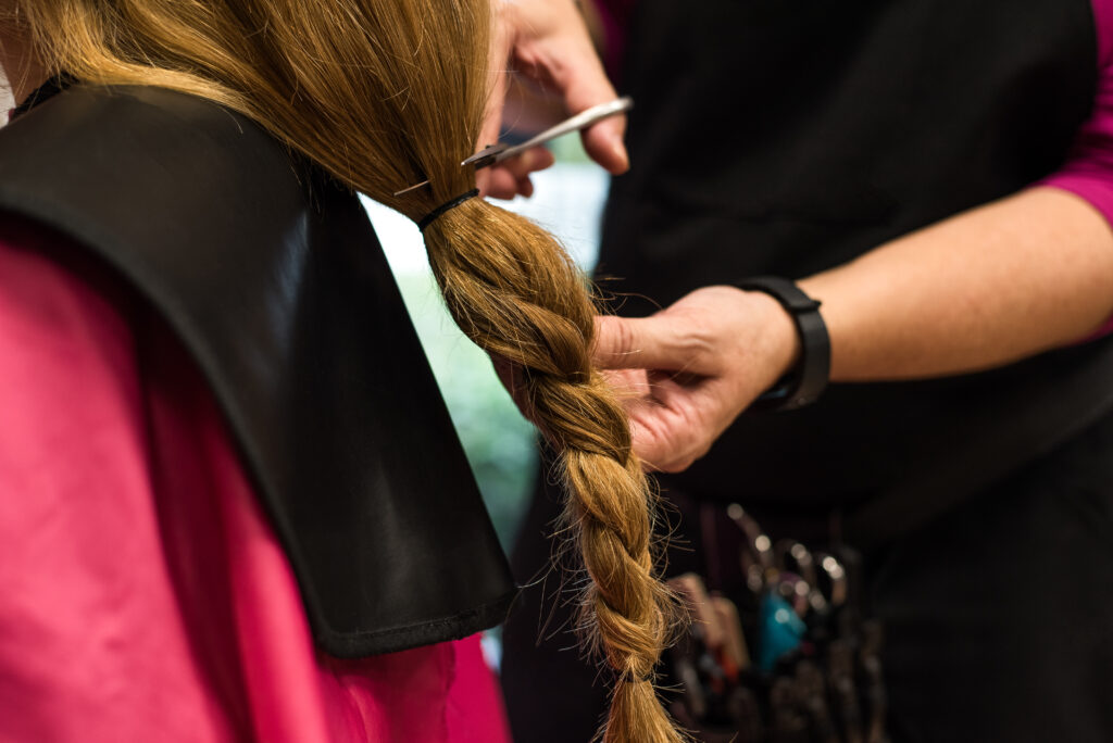 Woman donating hair for cancer. Hair care. Hair Treatment for dry hair. Cutting hair.