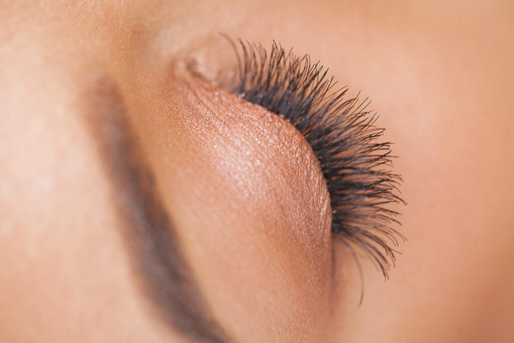 Woman Eye with Long Eyelashes. Beautiful Young Woman During Eyelash Extension.