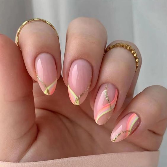 colored graphic French manicure, a faceless woman wearing gold rings.