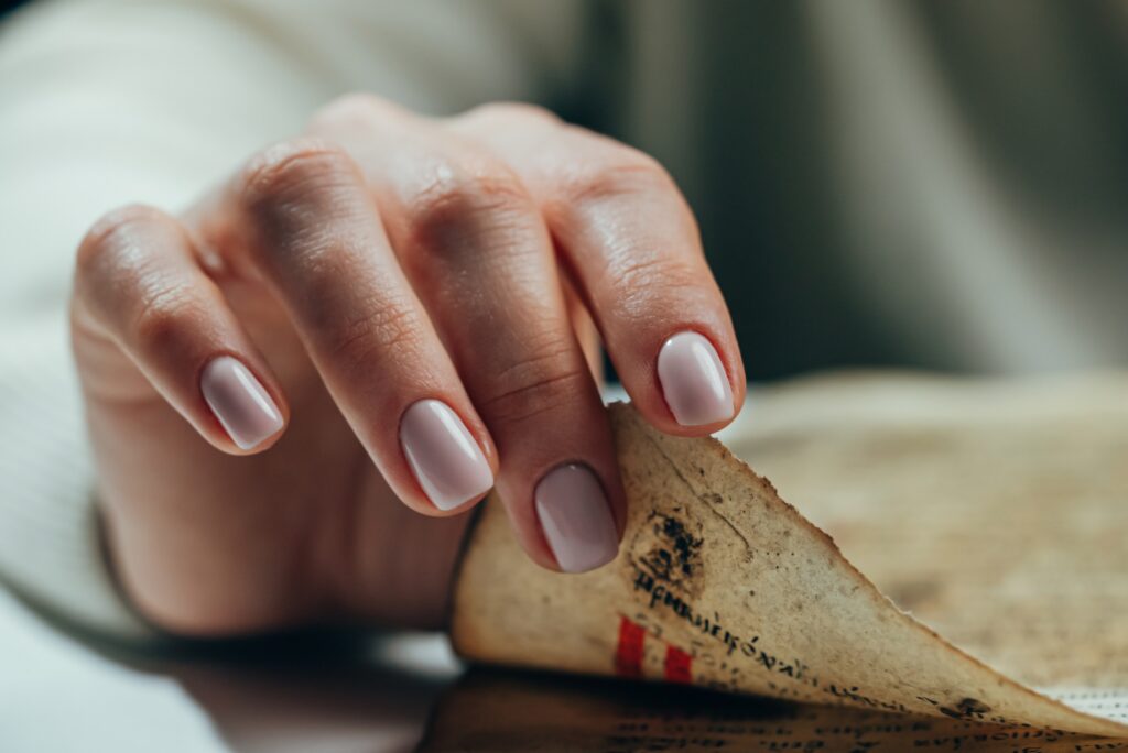 Woman flipping through pages of antique book. Lady with Bible. Concentrated lady looking for information from old archival manuscripts. History concept. High quality