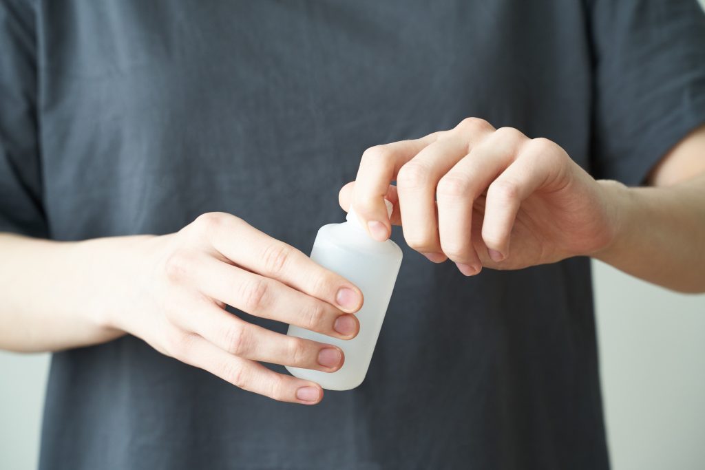 Woman wash hand sanitizer gel, to prevent illness Novel coronavirus (2019-nCoV) after public place. Antiseptic, Hygiene and Healthcare concept