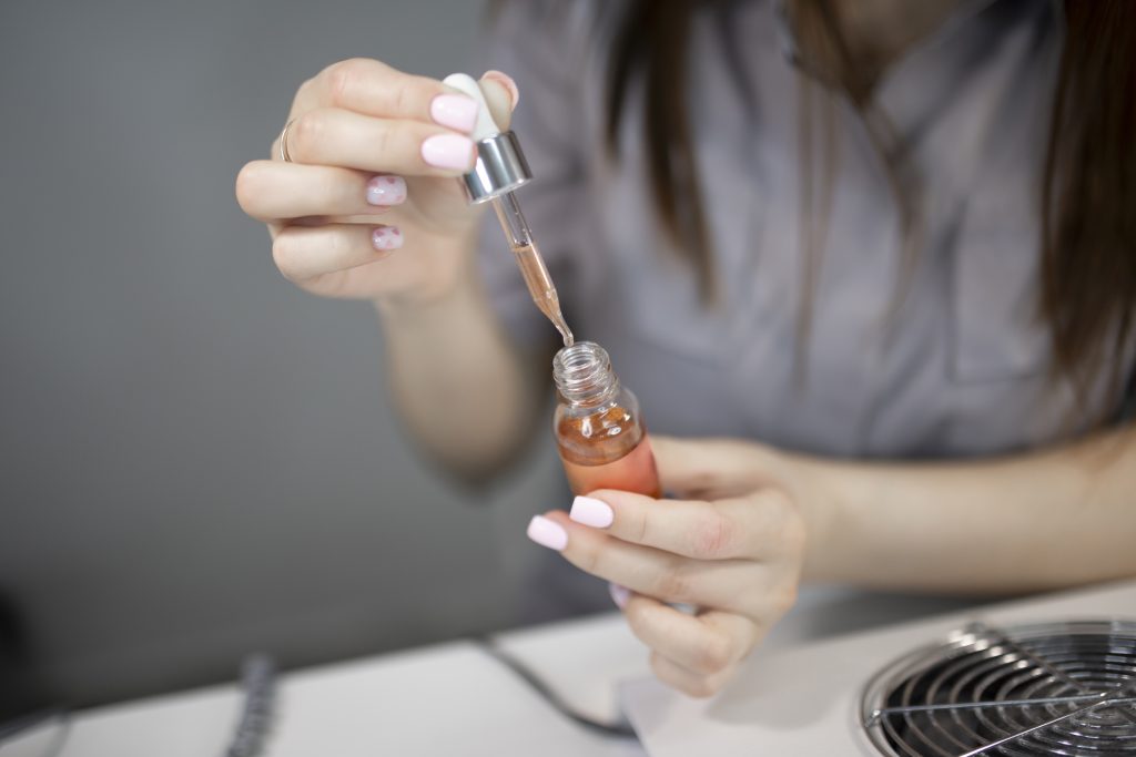 nail master doing manicure to a client in beauty spa salon