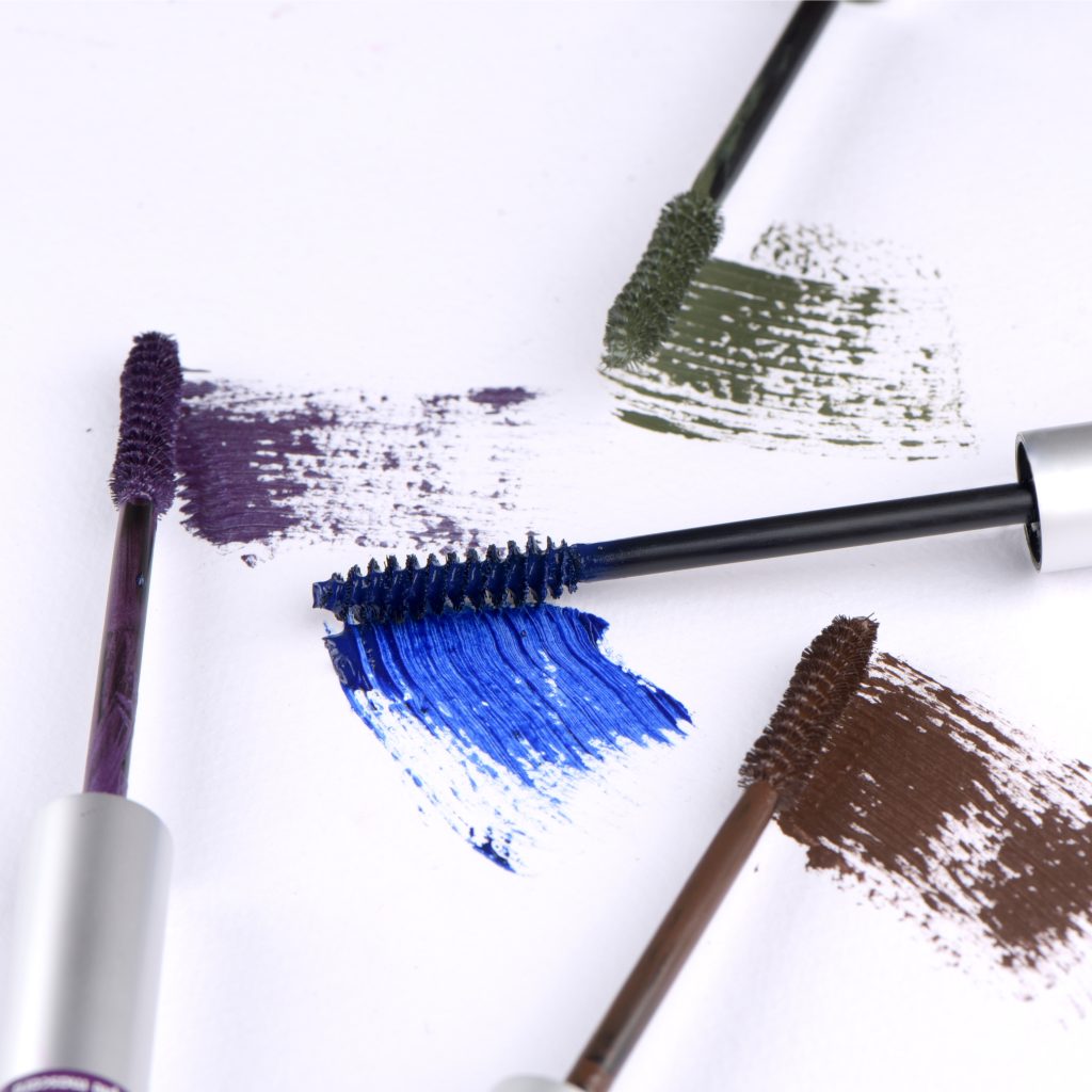 A closeup shot of colorful mascaras on white background