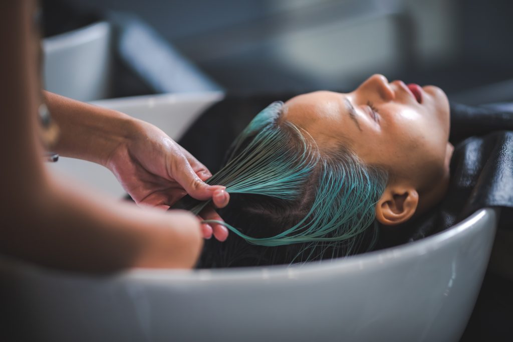 Growing Out Short Hair. hairdresser washing client's hair at salon. happy young women customer relax and comfortable while washing hair, luxury hair spa by professional hairstylist.